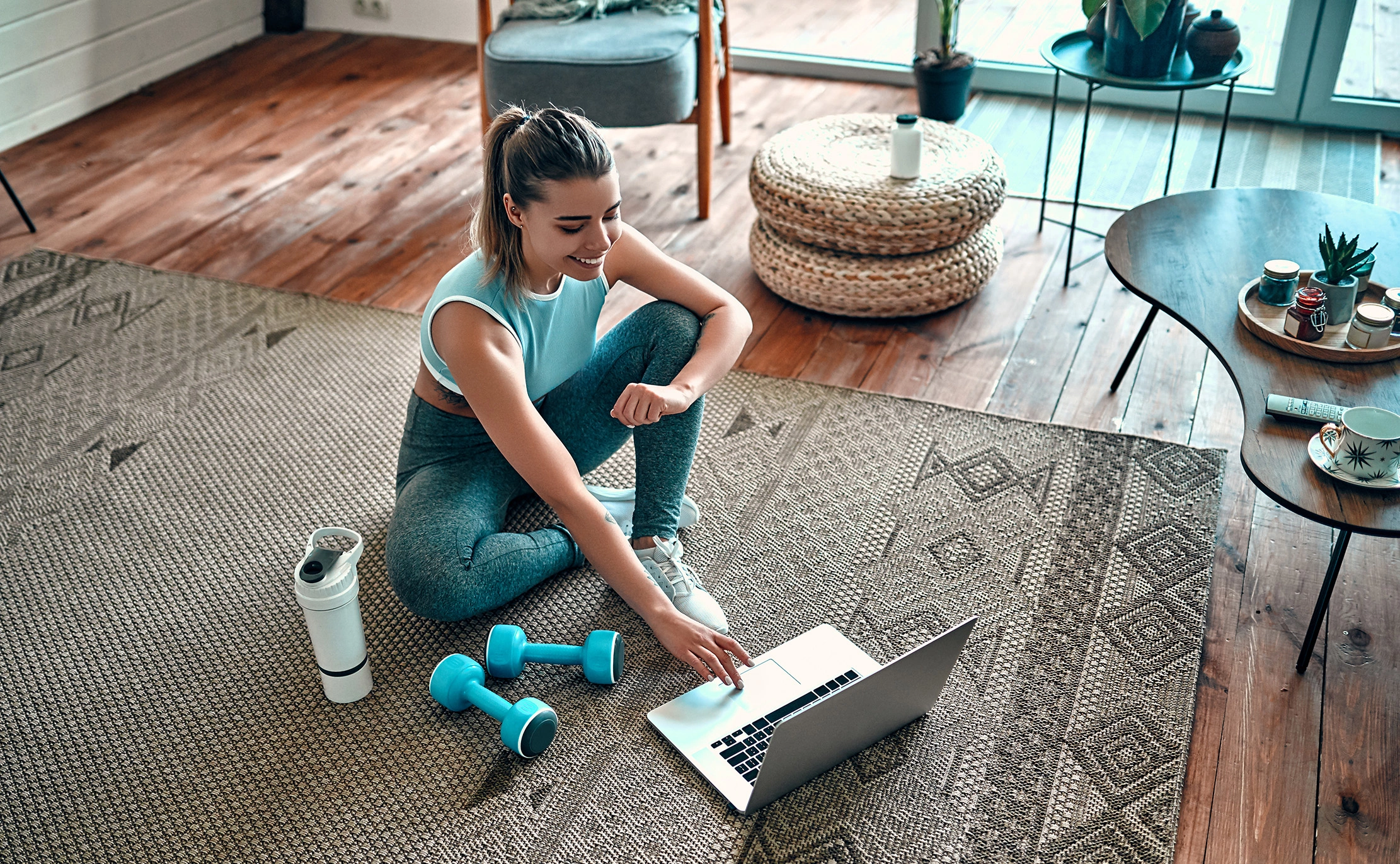 woman on laptop doing an at-home workout