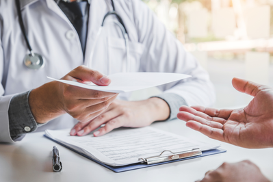 provider handing prescription to patient