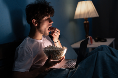 guy eating in bed